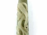 an image of a piece of carved jade on a white surface