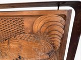 a wooden chair with a rooster carving on the back