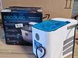 a white and blue cooler sitting on top of a cardboard box