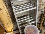 a bucket of sprinkles sitting on a pallet next to a ladder