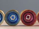 a lot of different colored discs on a wooden table