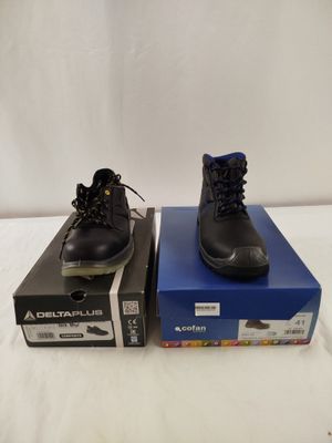 two pairs of black shoes sitting on top of a blue box