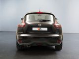 the back end of a black nissan qxv parked in a showroom