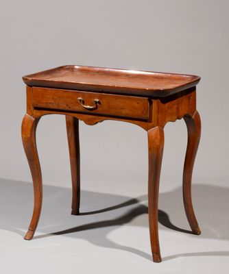 a small wooden table with a drawer on top of it