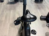 a row of stationary exercise bikes in a gym
