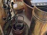 a lot of antique brass items on display in a store