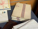 many folded napkins and ties on a table