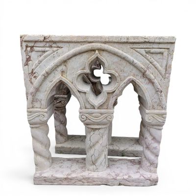 a stone sculpture of a cross in a window