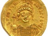une pièce d'or à l'effigie d'un homme portant une coiffe