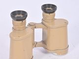 a pair of binoculars sitting on a white surface