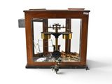 a small wooden clock with a glass case on it