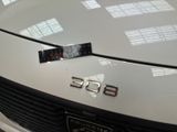 a close up of a white car with a number plate on it