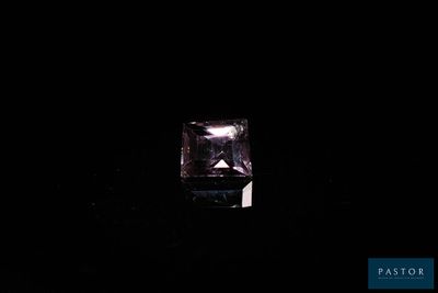 a purple diamond in the dark with a black background