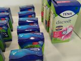 many boxes of toothpaste on the counter in the bathroom
