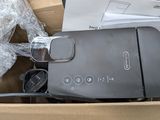 a black toaster sitting in a box on a table