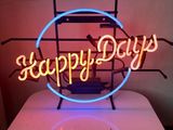the neon sign is on top of a table in a room