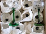 many wine glasses in a box with white napkins