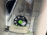 a dishwasher with a green button on it in a kitchen
