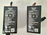 two batteries on a white surface with a white background