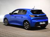 the rear end of a blue car parked on a checkered floor