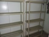 two shelvings in the corner of a room