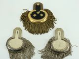 two pairs of fringed earrings and a gold and black broochle