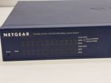 the netgear router is sitting on a white table
