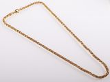 a gold necklace with a chain on a white background
