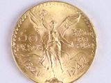 a gold coin with a angel on it on a white surface