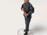 a figurine of a man with a gun in his hand