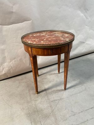 a small table that has a marble top on it