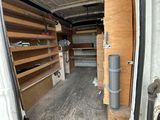 a white van that has some shelves in the back of it