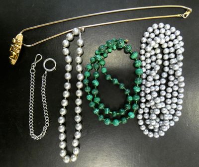 a close up of a bunch of beads and chains on a table