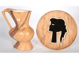 un vase en bois et une assiette en bois sur laquelle est représentée une femme