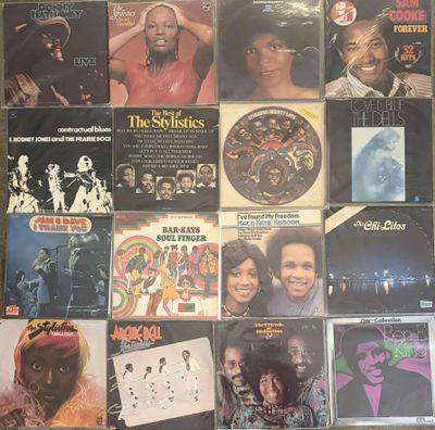 many records are stacked on top of each other on a table
