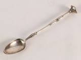 a spoon that is sitting on a white surface