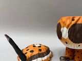 a stuffed animal that is sitting next to a pair of scissors