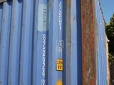 a blue container that has a yellow sign on it