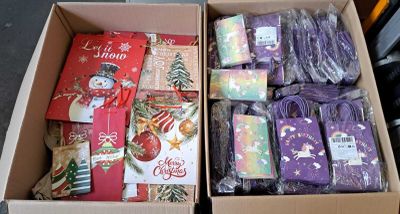 two boxes of christmas presents in the box on the floor