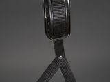 a metal bowl with a black strap on top of it