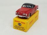 a red toy car sitting on top of a yellow box