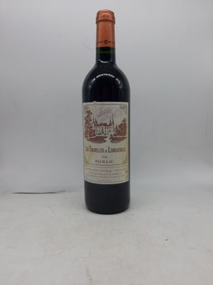 une bouteille de vin rouge posée sur une table blanche