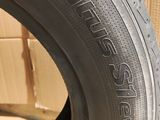 a close up of a tire on a table with a cardboard box in the background