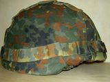 a close up of a camouflage helmet on a table