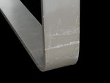 a close up of a white marble bench against a black background
