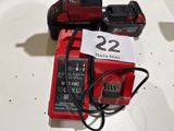 two batteries and a charger on a table