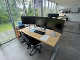 an image of an office with two computer screens on the desk