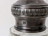 a silver salt and pepper shaker sitting on a table