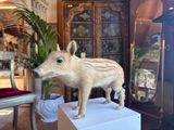 a statue of a boar on a pedestal in a living room
