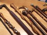 many different types of walking canes on a table